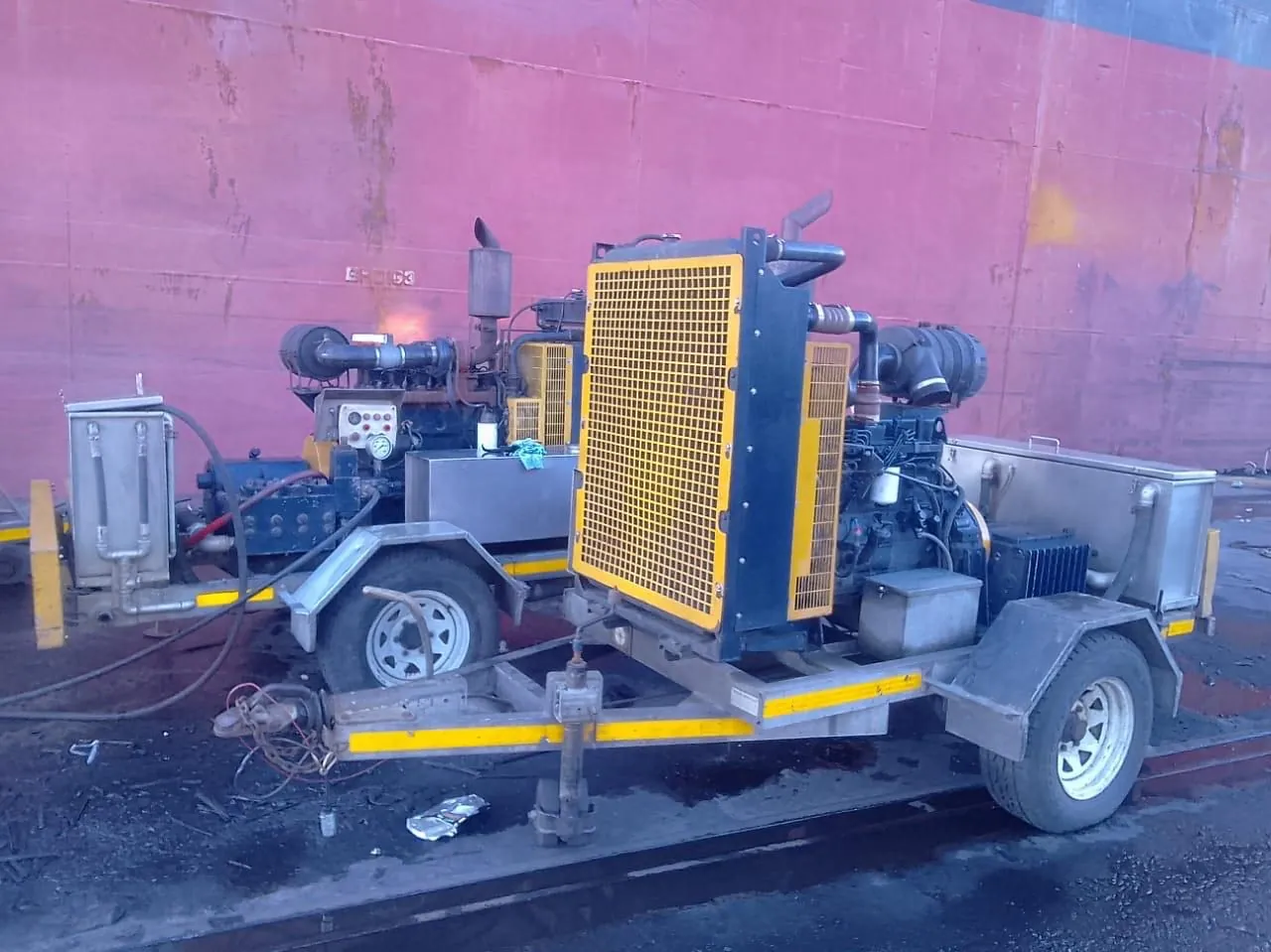 Equipment deployed alongside a ship hull at the port